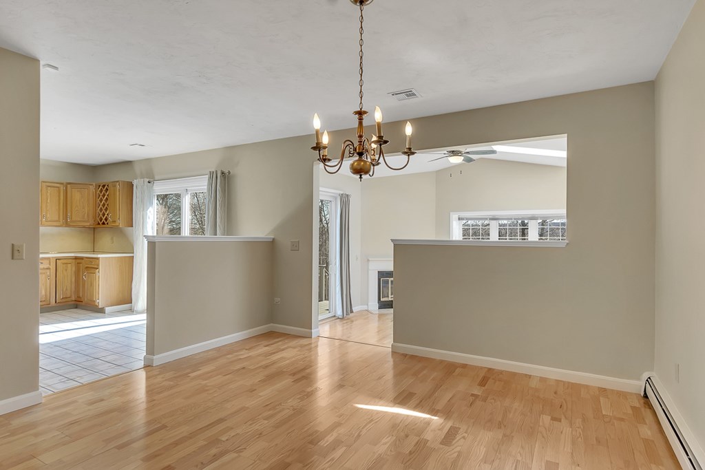 307 Ridgefield Circle, Unit A Clinton, MA 01510 - Photo 10 of 42 a view of a room with wooden floor and kitchen view
