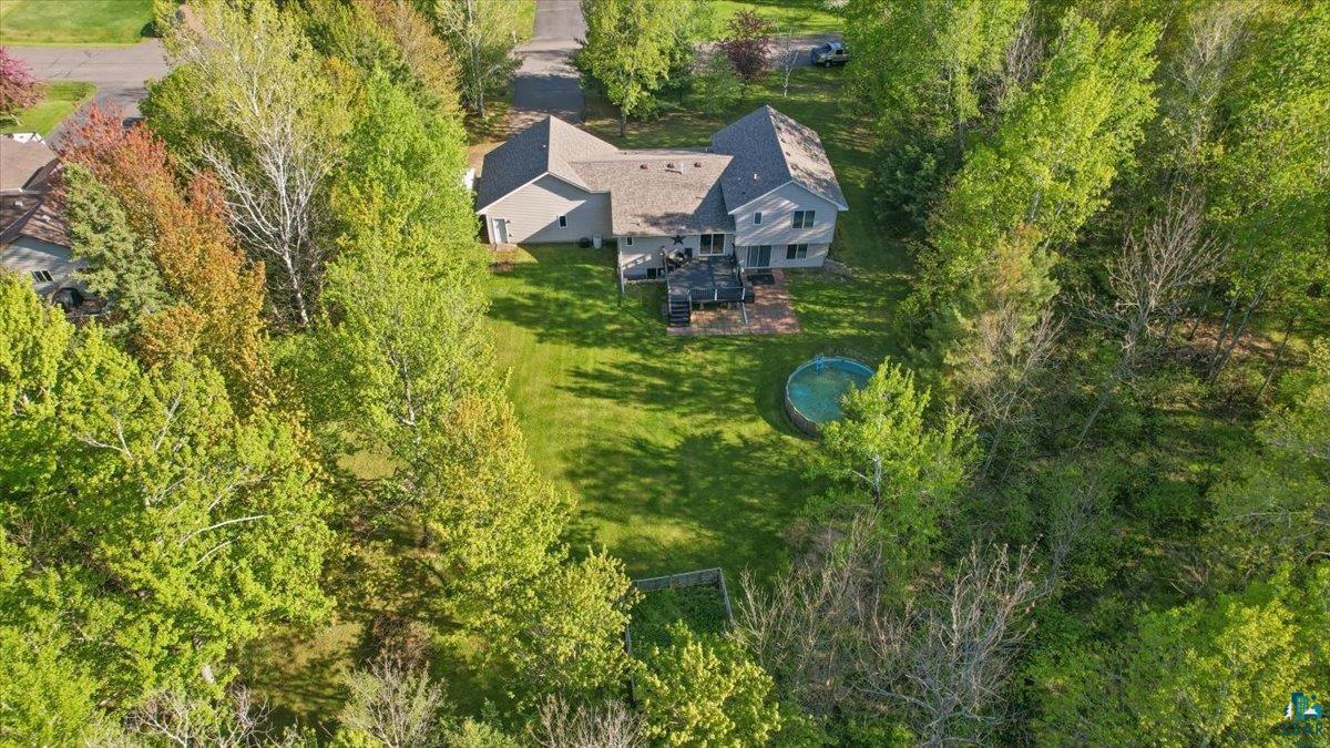 47 Amy Lane Esko, MN 55733 - Photo 31 of 33 Spacious property featuring a light-colored exterior, multi-level deck, and surrounding mature trees