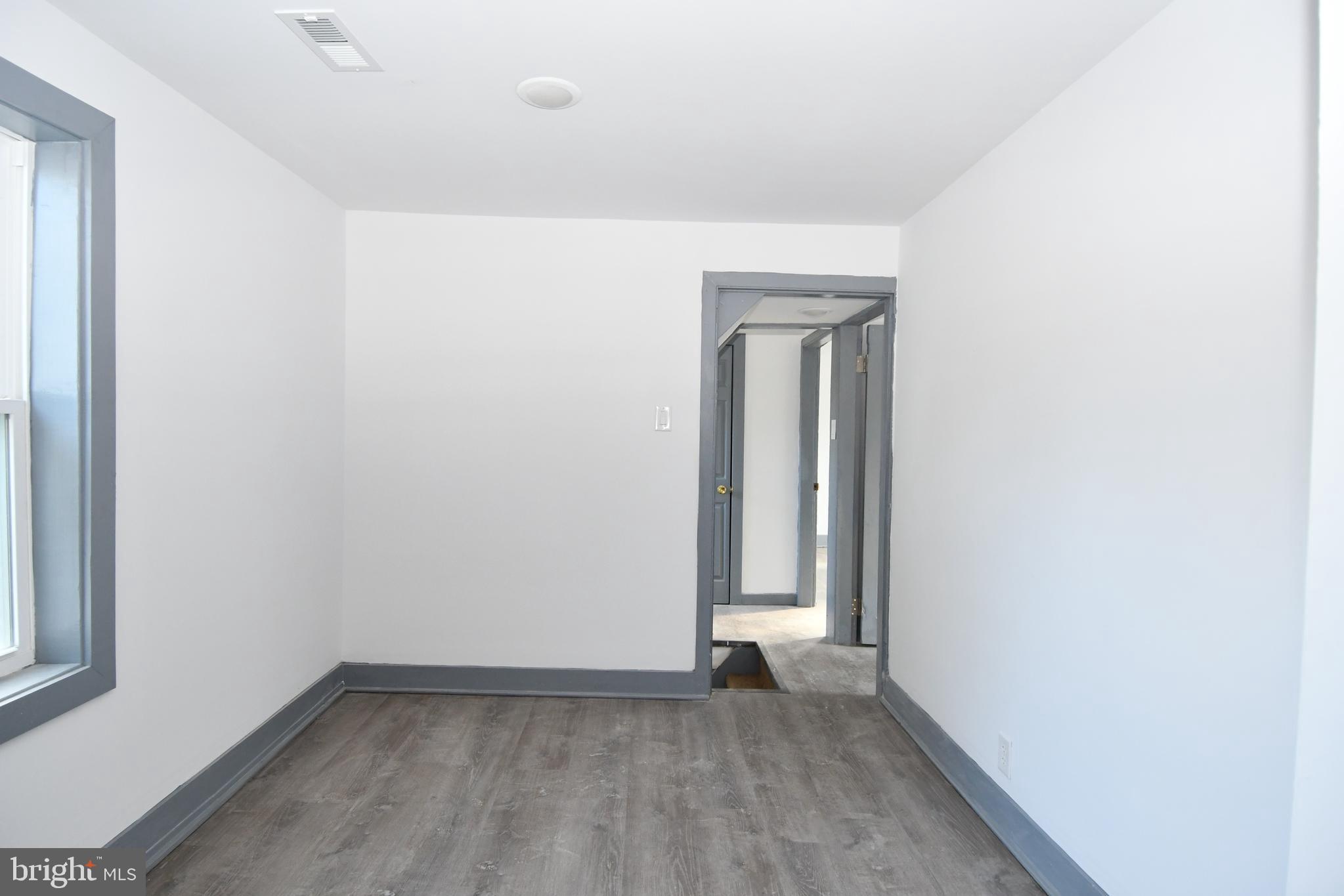 780 White Hall Road Littlestown, PA 17340 - Photo 11 of 19 an empty room with wooden floor and windows