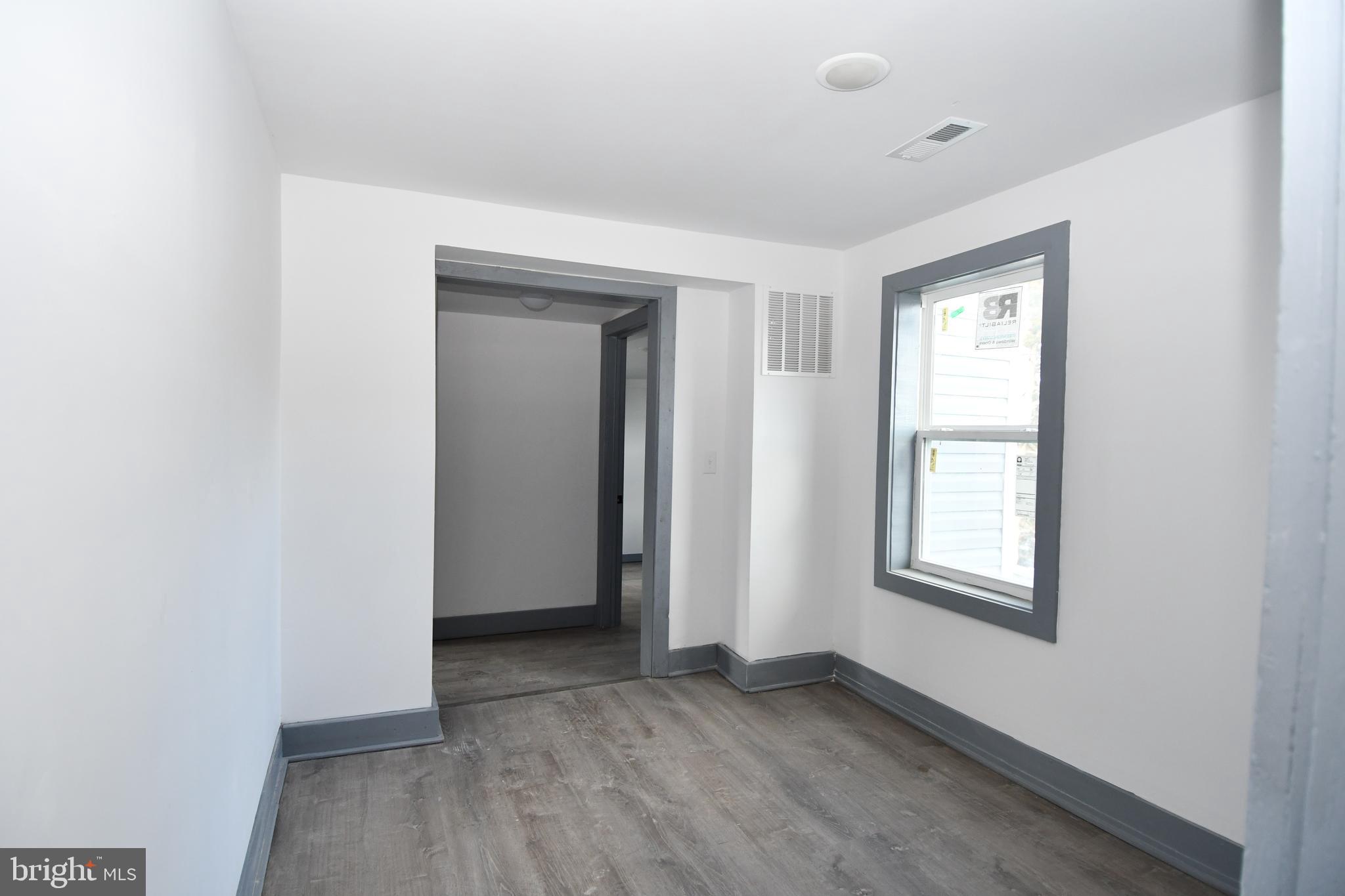 780 White Hall Road Littlestown, PA 17340 - Photo 16 of 19 an empty room with wooden floor and windows