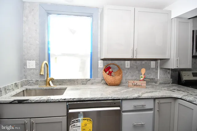 a kitchen with granite countertop a sink and a window