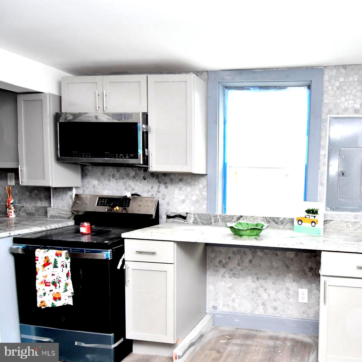 780 White Hall Road Littlestown, PA 17340 - Photo 5 of 19 a kitchen with stainless steel appliances kitchen island granite countertop a sink a stove a microwave a refrigerator and cabinets