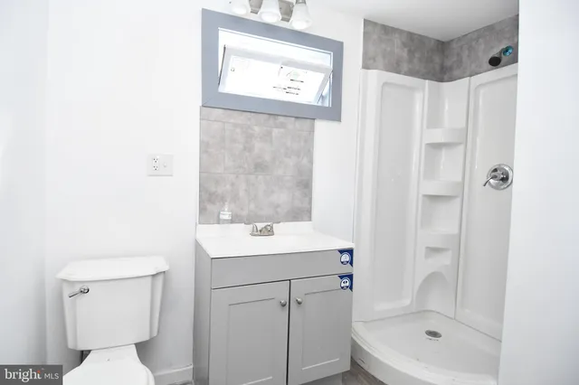 a bathroom with a toilet sink and shower