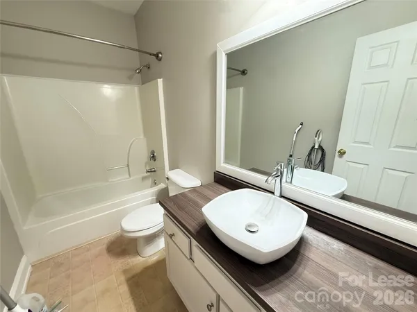 a bathroom with a sink toilet a mirror and shower