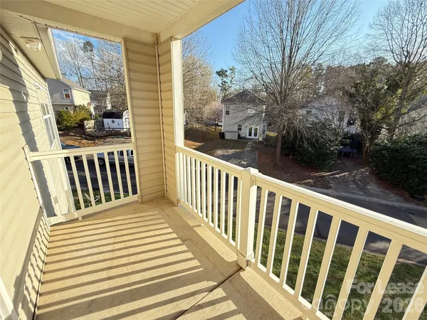 a view of a balcony with wooden floor