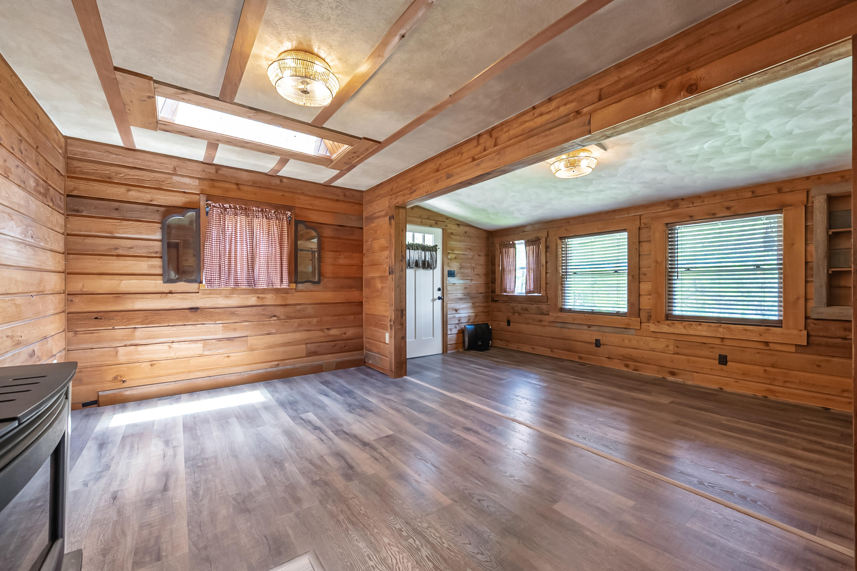 2389 Reesedale Road Elliston, VA 24087 - Photo 13 of 62 a view of an empty room with wooden floor and a window