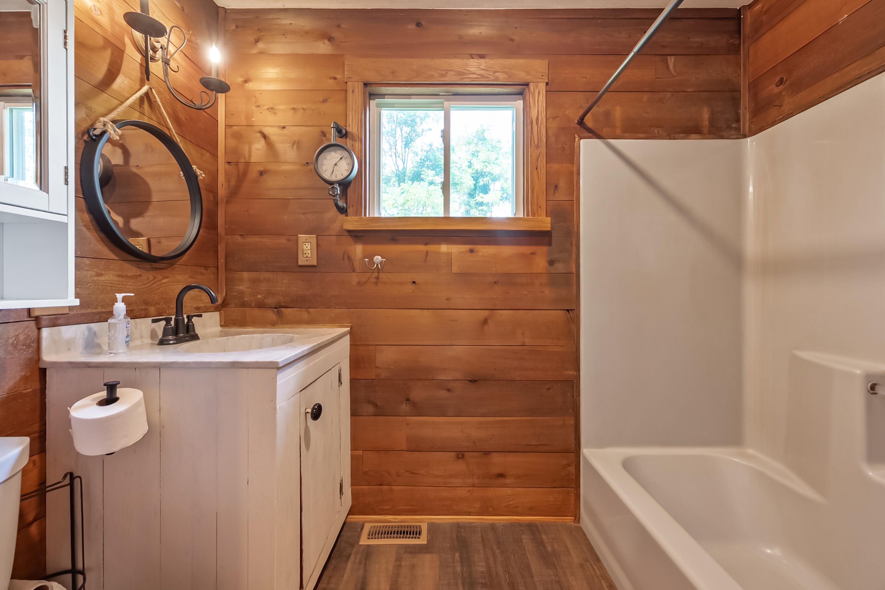 2389 Reesedale Road Elliston, VA 24087 - Photo 30 of 62 a bathroom with a sink a mirror and a bathtub