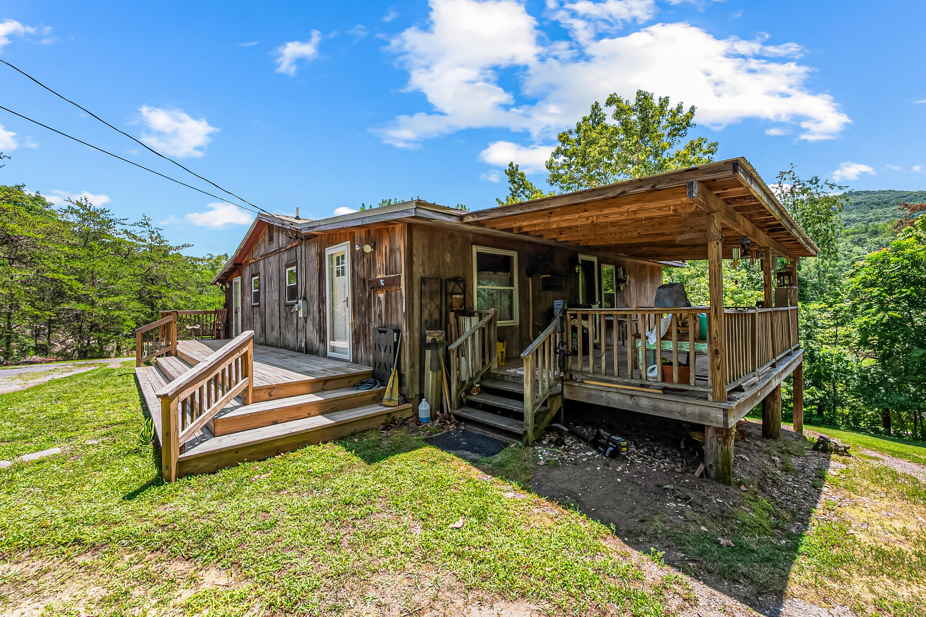 2389 Reesedale Road Elliston, VA 24087 - Photo 4 of 62 a view of a house with a wooden deck and furniture