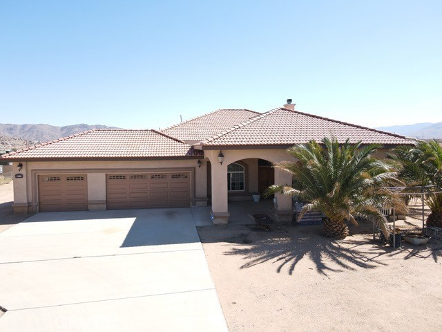 11896 Joshua Road Apple Valley, CA 92308 - Photo 1 of 1 a front view of a house with garden