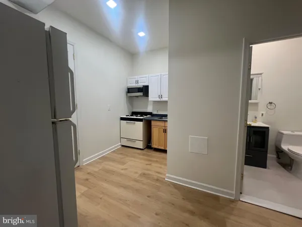 a kitchen with a refrigerator and a stove top oven