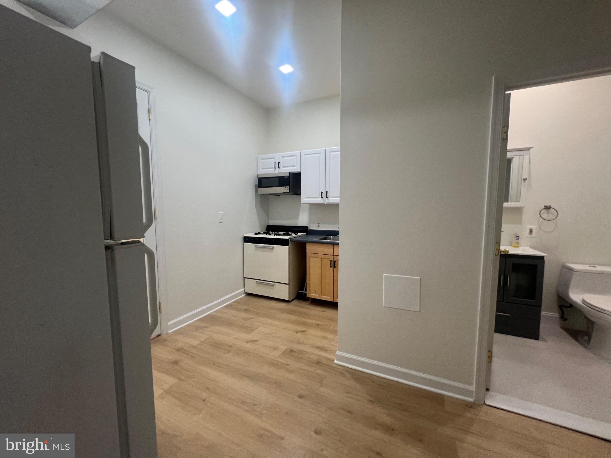 1324 H Street Northeast, Unit 2 Washington, DC 20002 - Photo 3 of 12 a kitchen with a refrigerator and a stove top oven