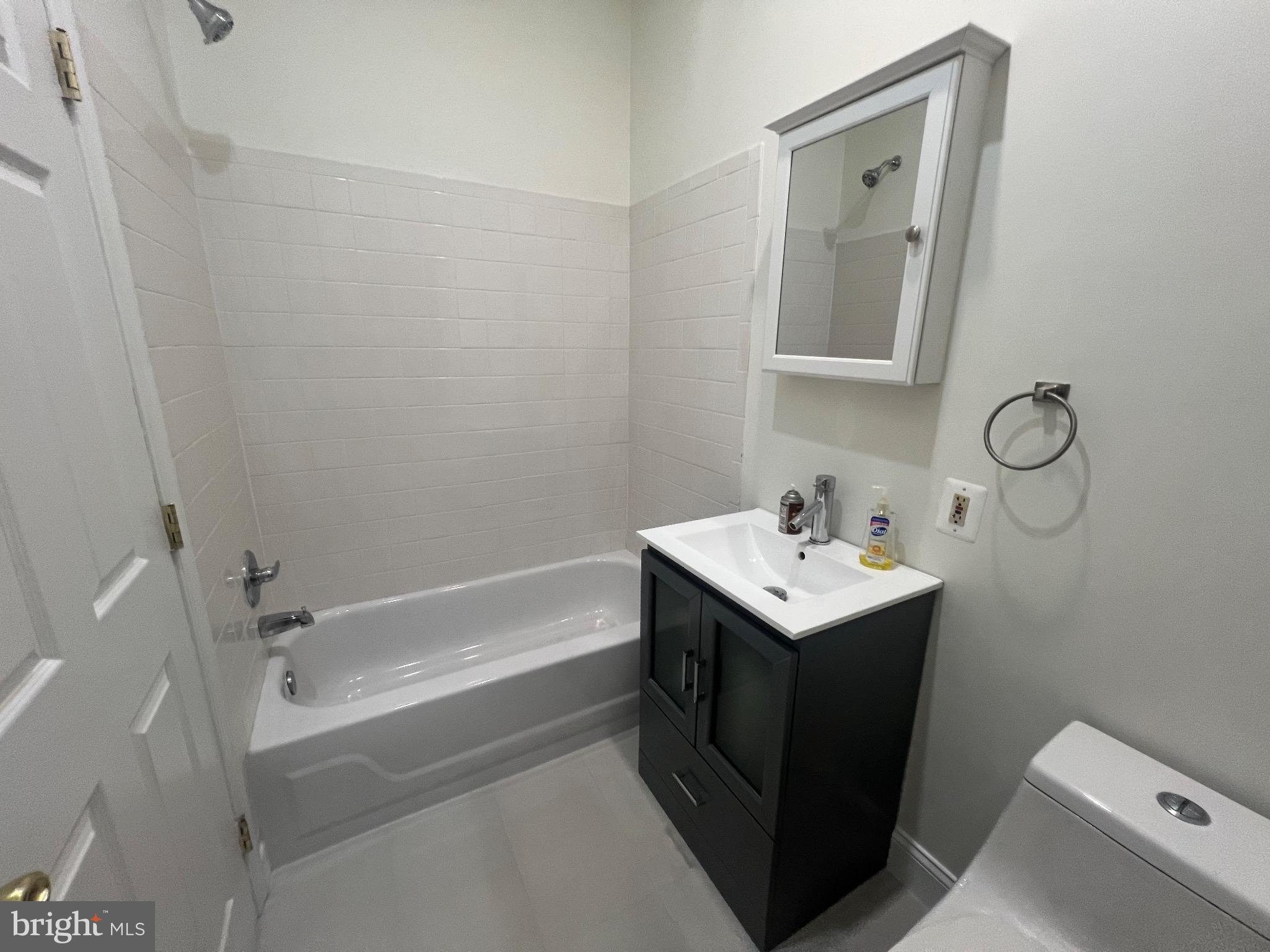 1324 H Street Northeast, Unit 2 Washington, DC 20002 - Photo 4 of 12 a bathroom with a sink toilet and vanity