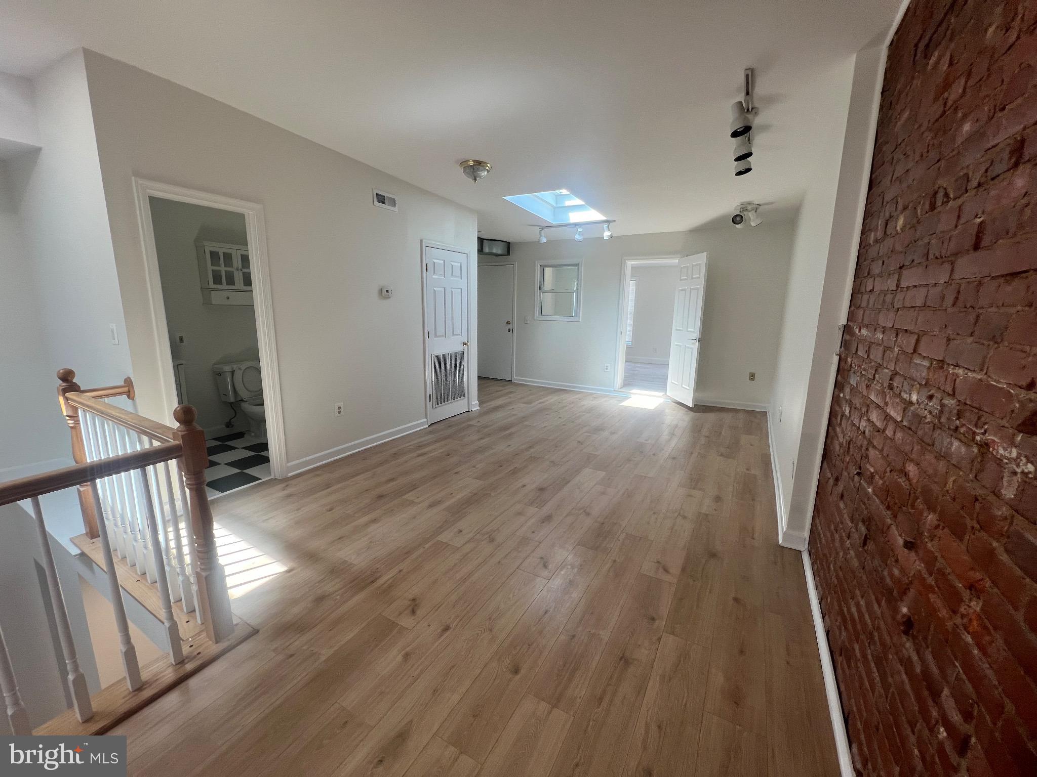 1324 H Street Northeast, Unit 2 Washington, DC 20002 - Photo 5 of 12 wooden floor in an empty room with a fireplace