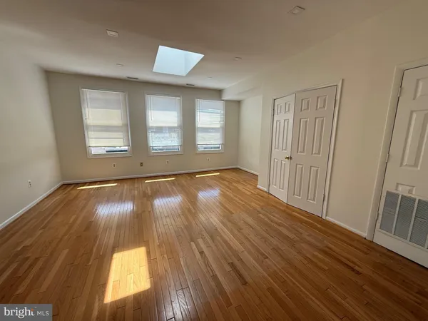 a view of an empty room and wooden floor