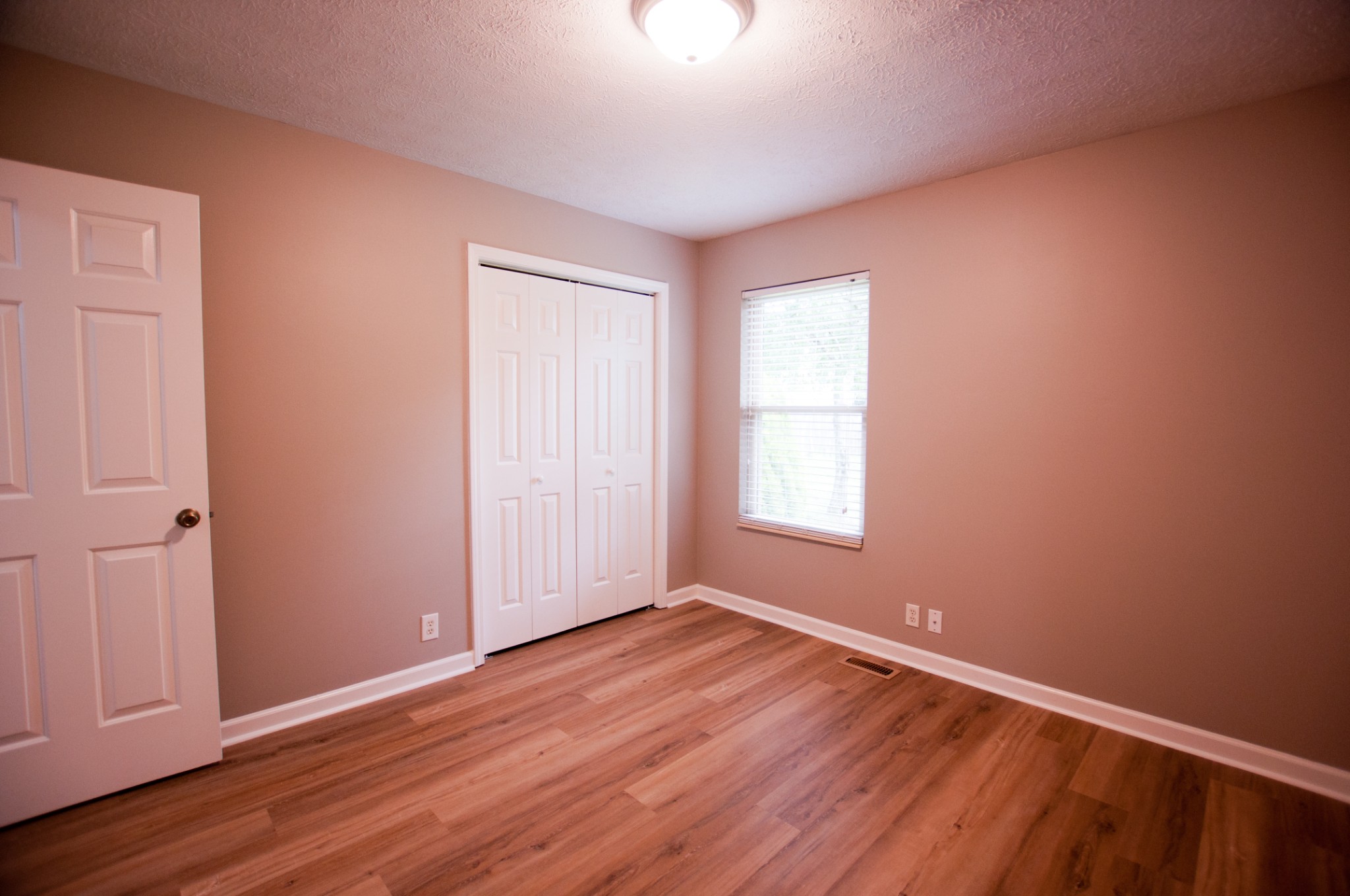 309 Chesterfield Circle Madison, TN 37115 - Photo 11 of 27 an empty room with wooden floor and windows