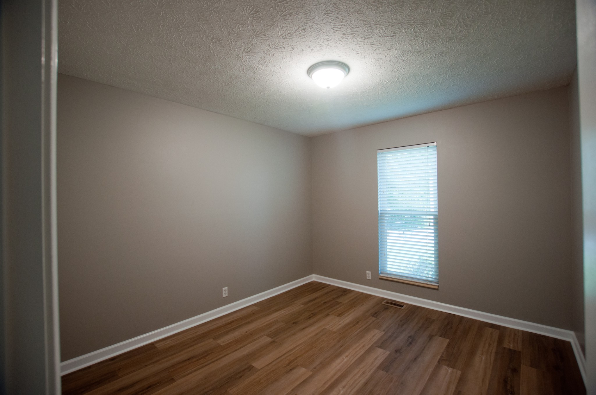 309 Chesterfield Circle Madison, TN 37115 - Photo 17 of 27 an empty room with wooden floor and windows