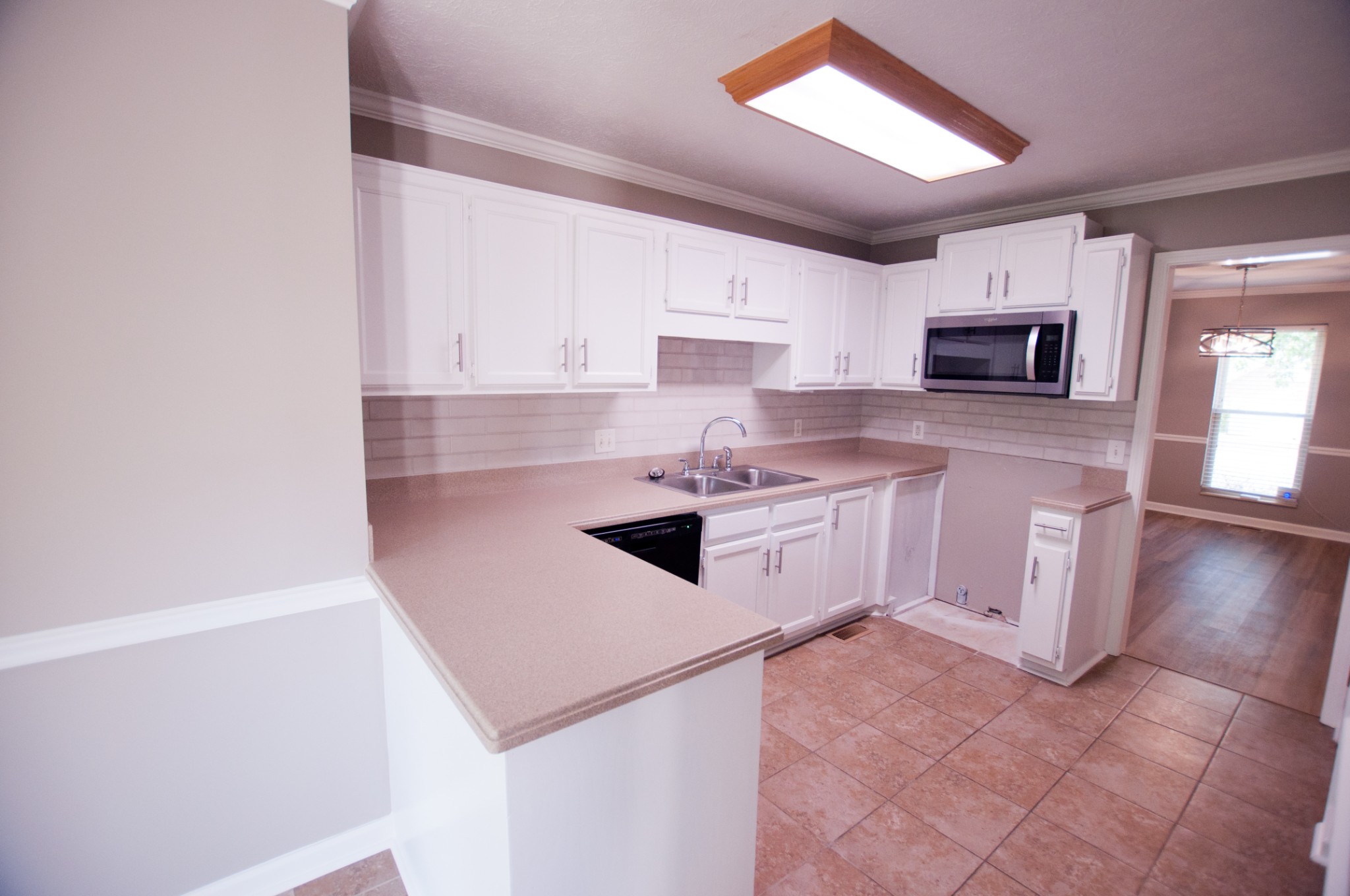 309 Chesterfield Circle Madison, TN 37115 - Photo 3 of 27 a kitchen with white cabinets and white appliances