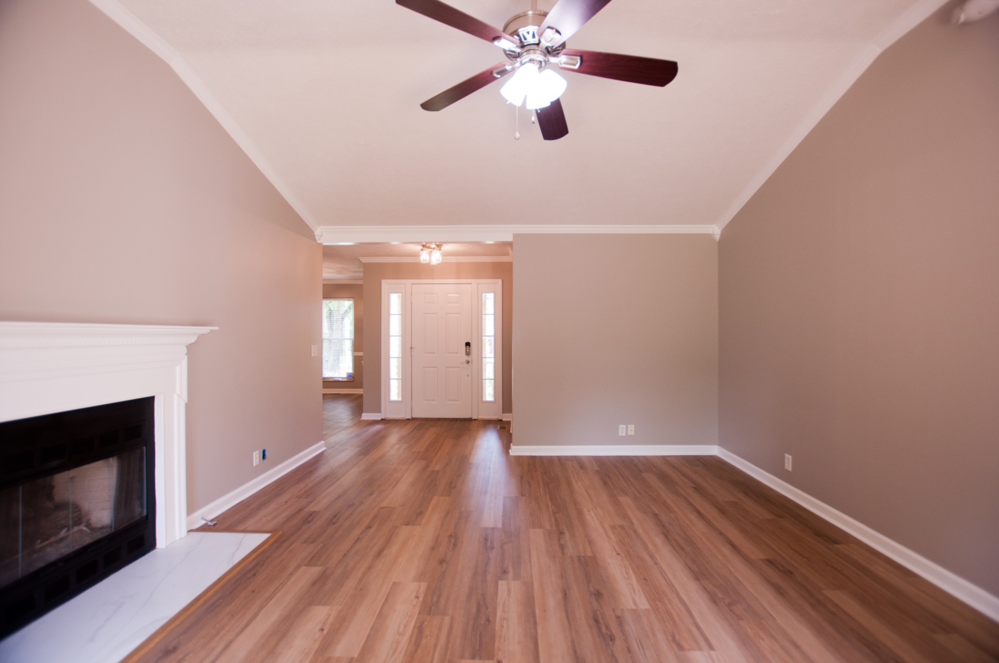 309 Chesterfield Circle Madison, TN 37115 - Photo 8 of 27 a view of an empty room with wooden floor and a fireplace