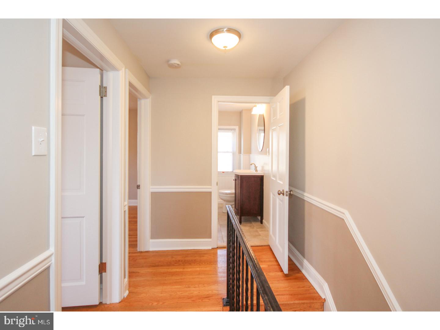 346 Ballymore Road Springfield, PA 19064 - Photo 13 of 24 a view of a hallway with wooden floor and cabinet