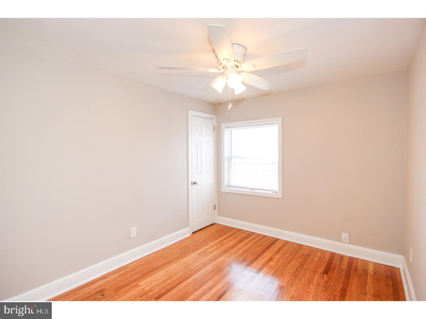 346 Ballymore Road Springfield, PA 19064 - Photo 16 of 24 an empty room with wooden floor and fan