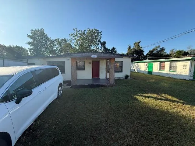 a view of backyard with deck and outdoor seating