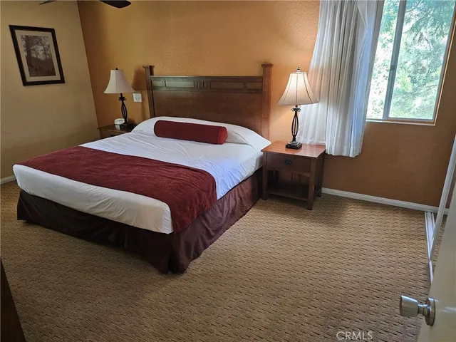 a bedroom with a bed lamp and window