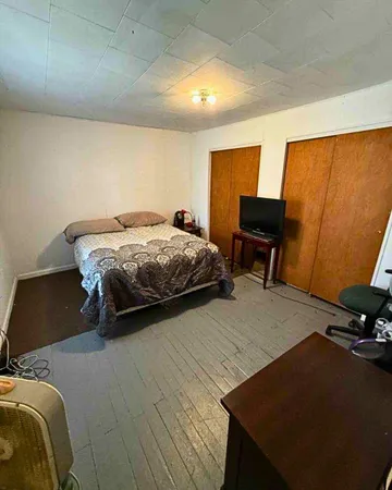 a bedroom with a bed and a desk