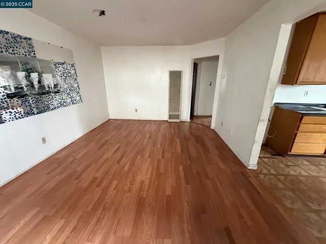 a view of a room with wooden floor and sink