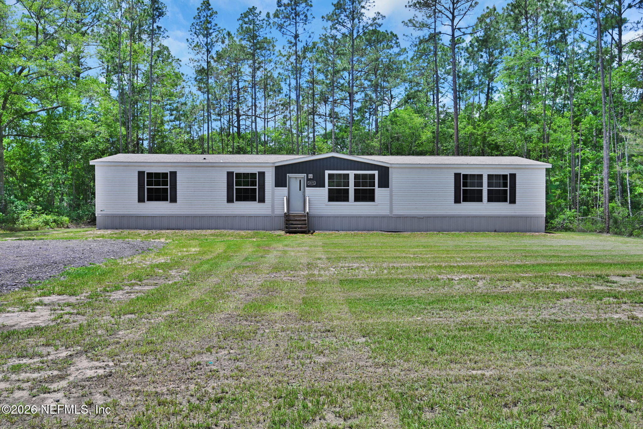 540783 Lem Turner Road Callahan, FL 32011 - Photo 5 of 36 a front view of house with yard and trees all around