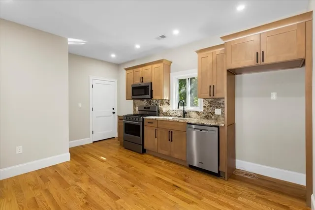 a kitchen with stainless steel appliances granite countertop a refrigerator sink and cabinets