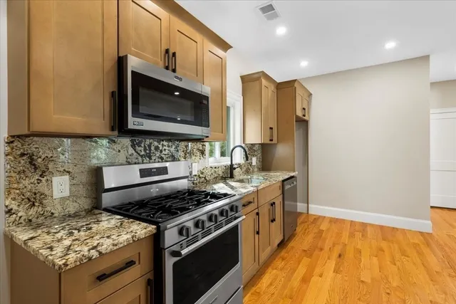a kitchen with a stove and a sink