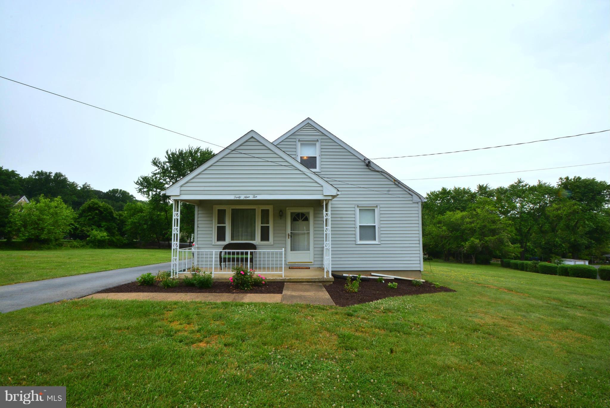 4910 Forge Road Perry Hall, MD 21128 - Photo 1 of 25 a backyard of a house with potted plants and large tree