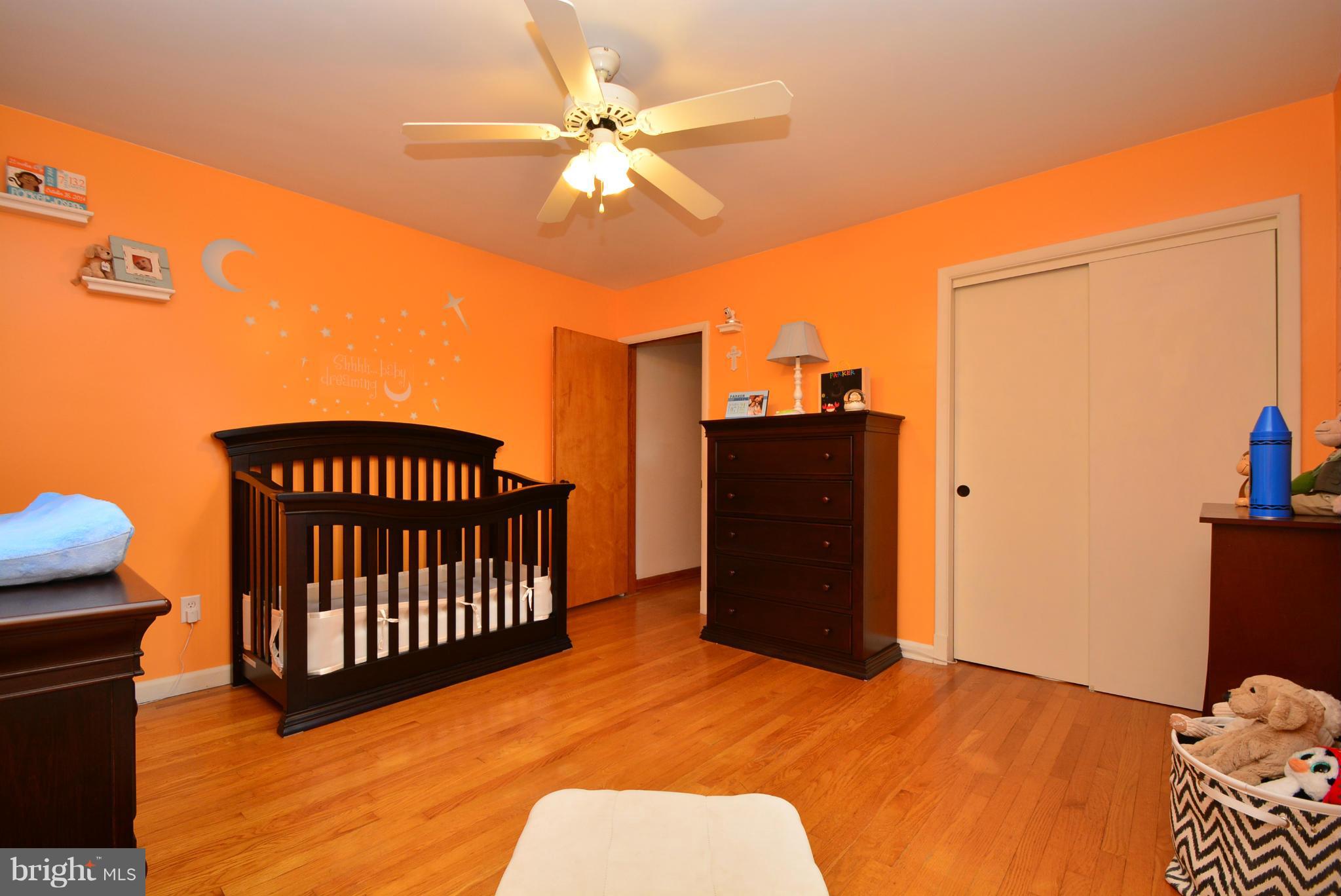 4910 Forge Road Perry Hall, MD 21128 - Photo 14 of 25 a bedroom with a bed and wooden floor