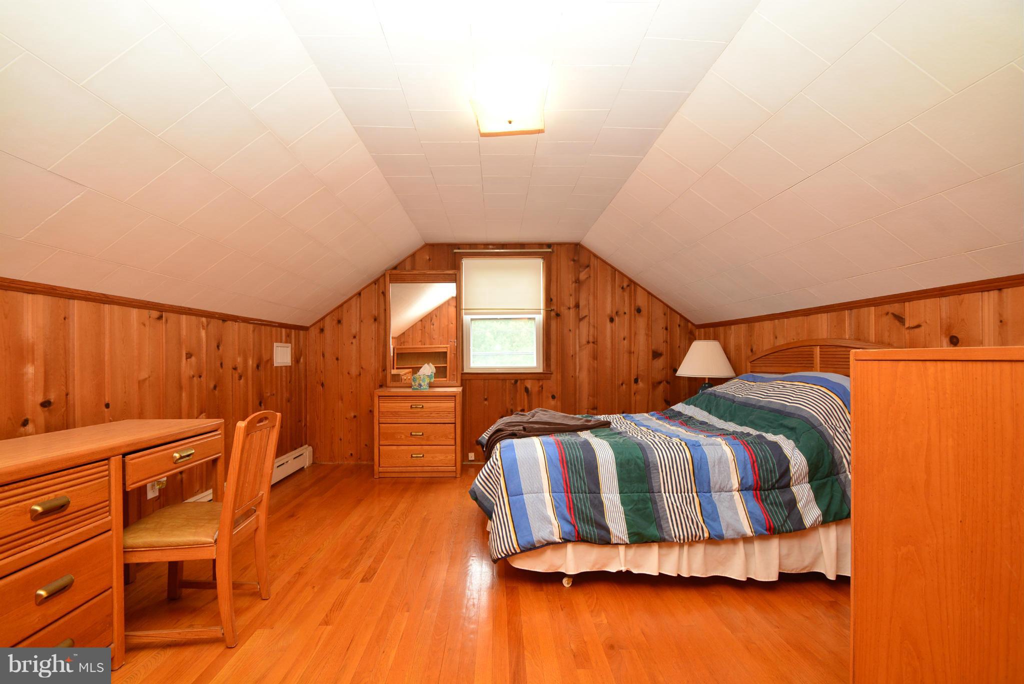 4910 Forge Road Perry Hall, MD 21128 - Photo 18 of 25 a bedroom with a bed and wooden floor