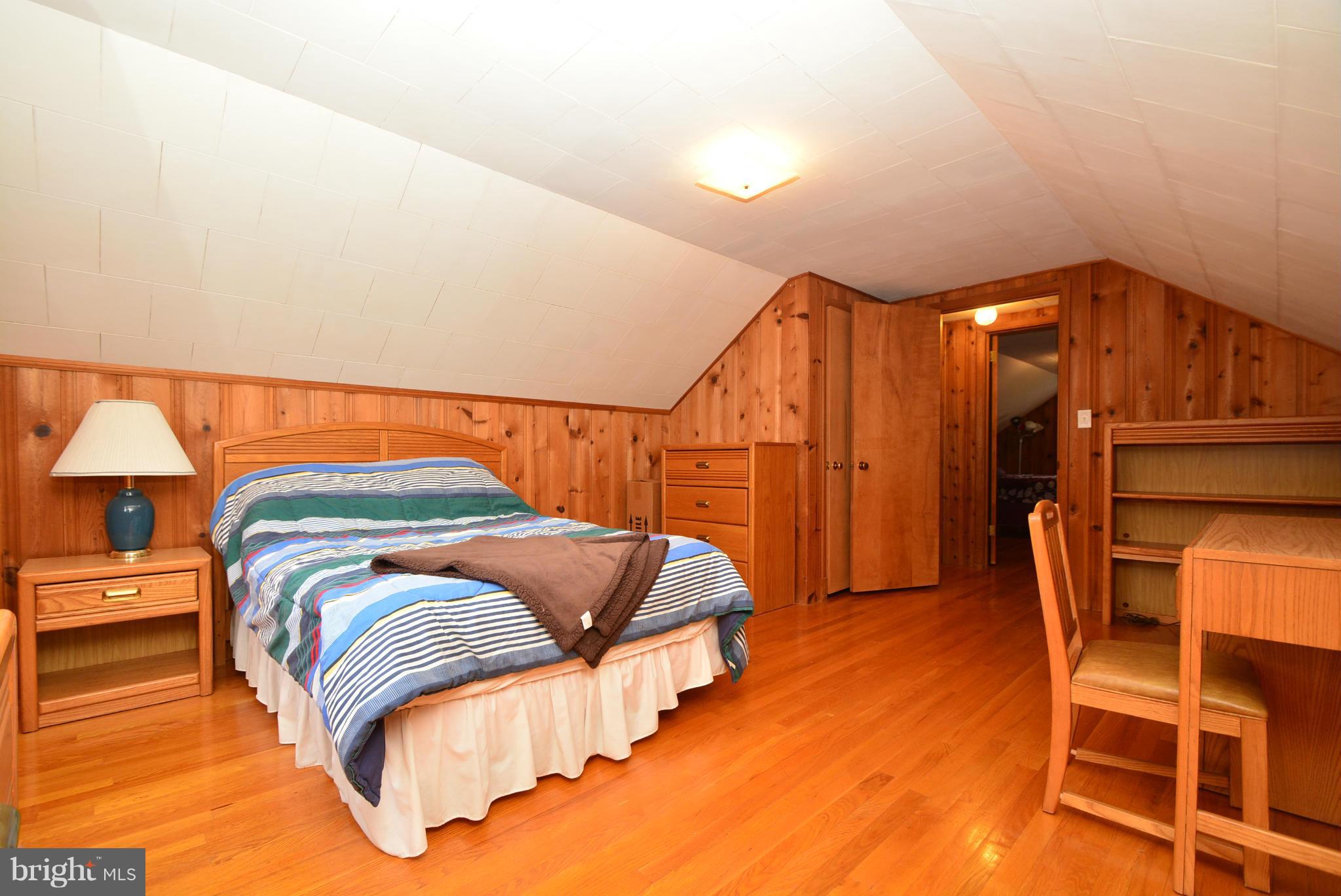 4910 Forge Road Perry Hall, MD 21128 - Photo 19 of 25 a bedroom with a bed and lamp with the view of bathroom
