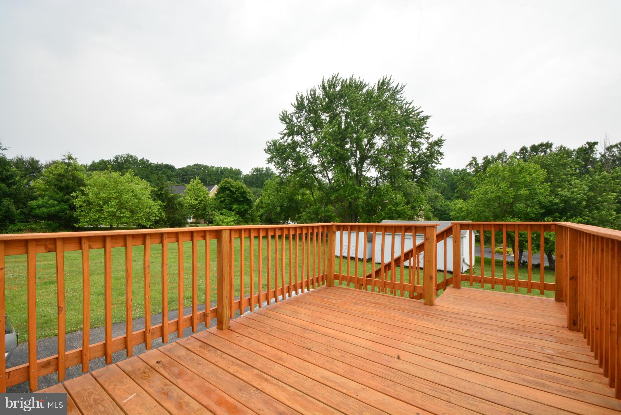 4910 Forge Road Perry Hall, MD 21128 - Photo 23 of 25 a balcony with wooden floor and trees in the background