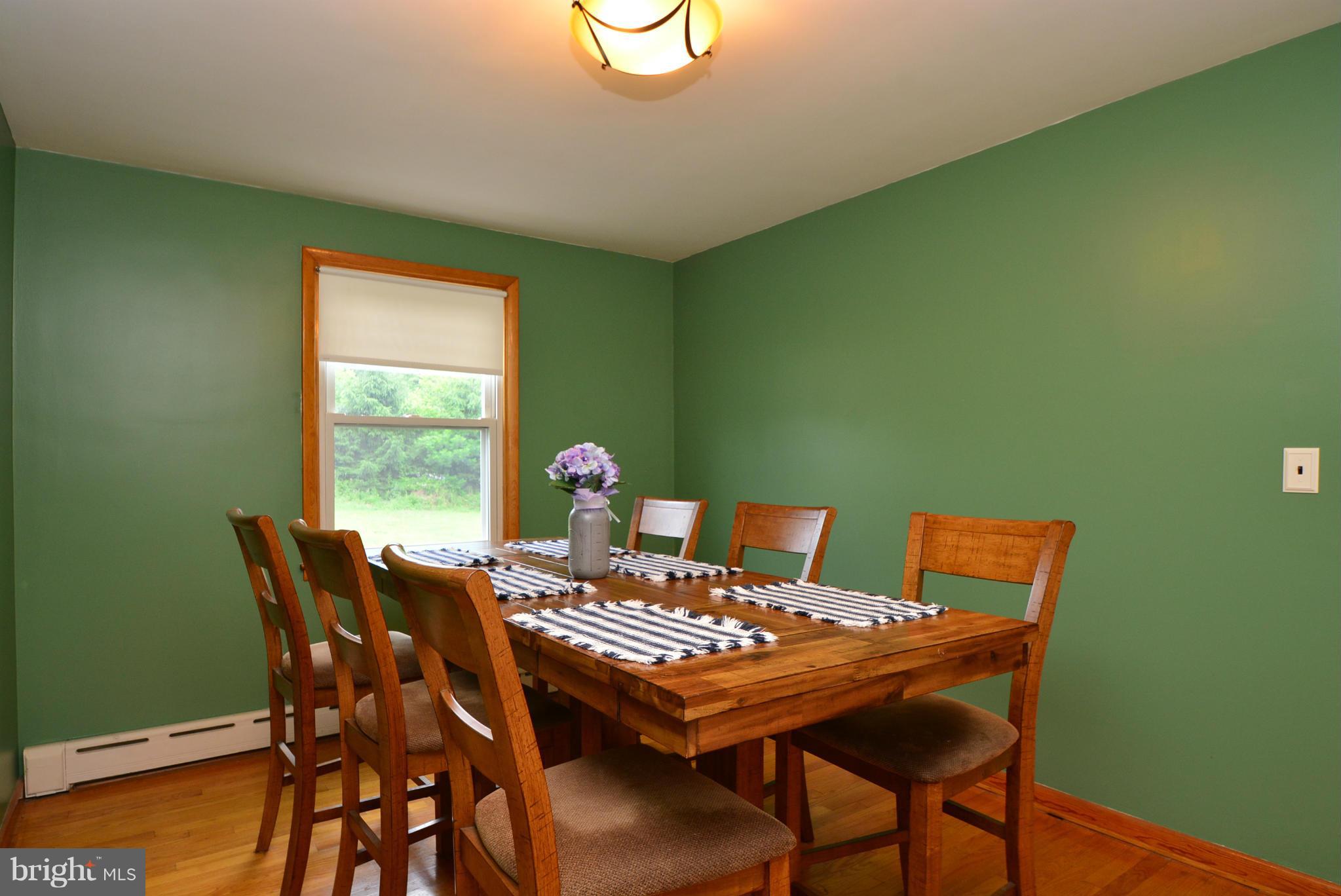 4910 Forge Road Perry Hall, MD 21128 - Photo 5 of 25 a view of a dining room that has a table and a chair with wooden floor