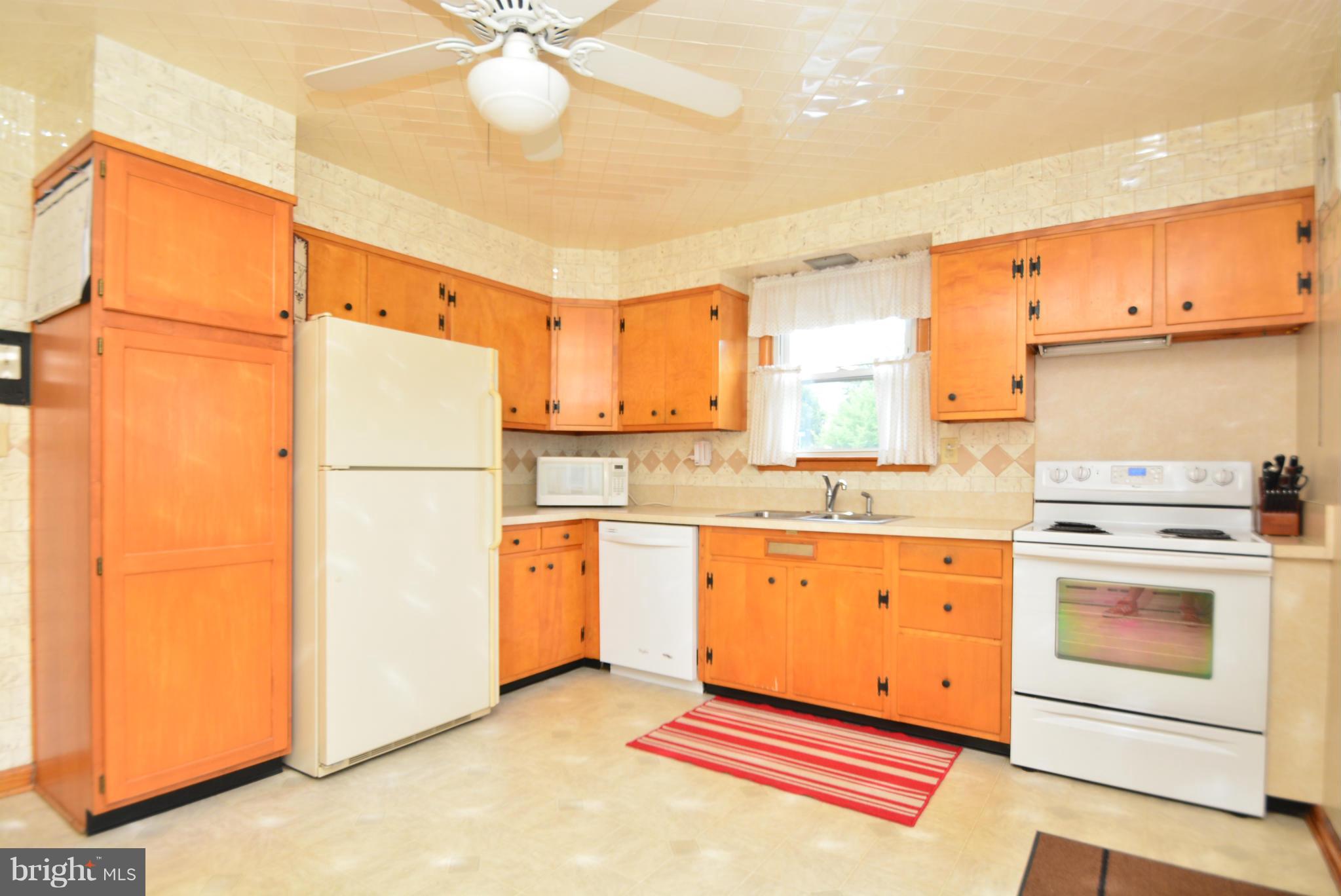 4910 Forge Road Perry Hall, MD 21128 - Photo 7 of 25 a kitchen with granite countertop appliances a sink and a refrigerator