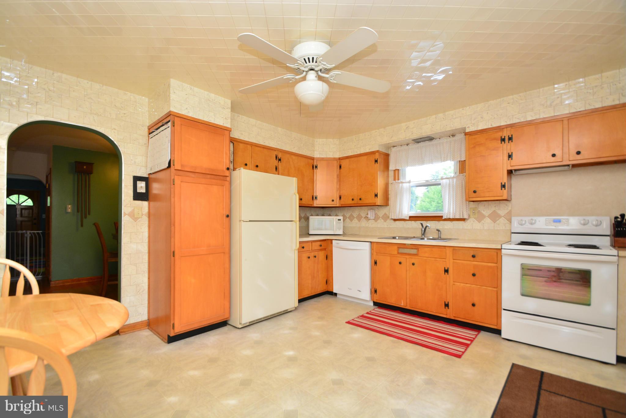 4910 Forge Road Perry Hall, MD 21128 - Photo 8 of 25 a kitchen with cabinets a refrigerator and a stove top oven
