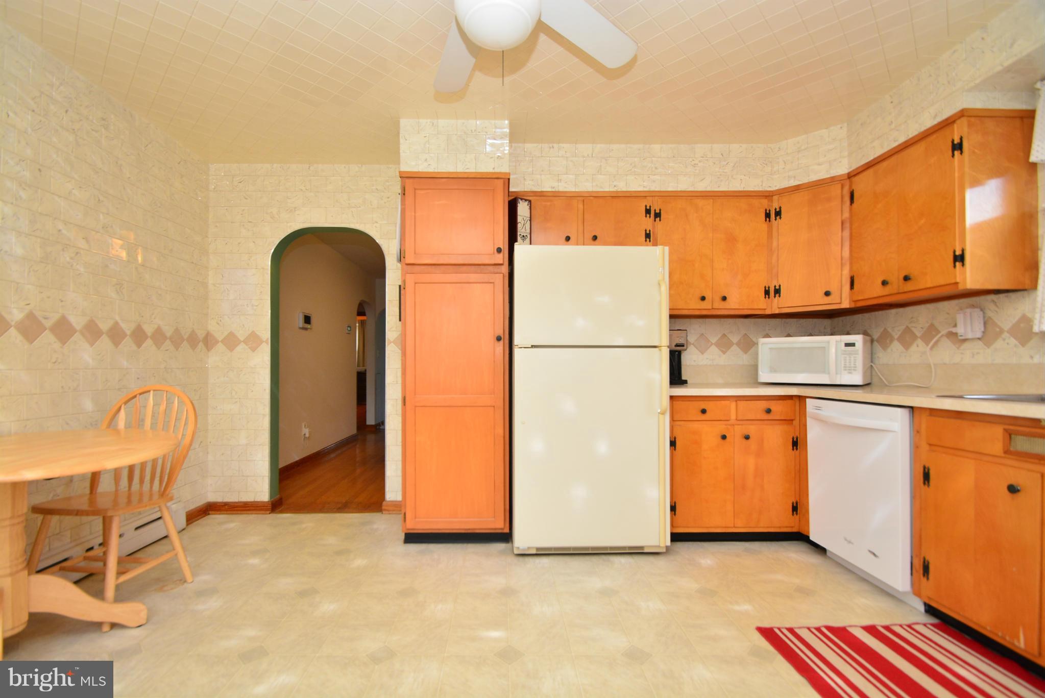 4910 Forge Road Perry Hall, MD 21128 - Photo 10 of 25 a kitchen with granite countertop a refrigerator a stove and a sink
