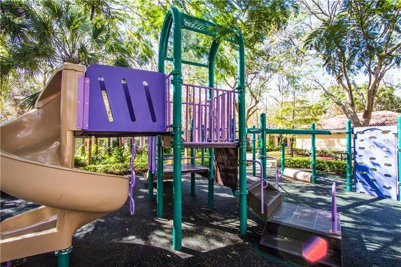 6670 West Sample Road, Unit 6670 Coral Springs, FL 33067 - Photo 14 of 16 a view of a chairs and table in a backyard