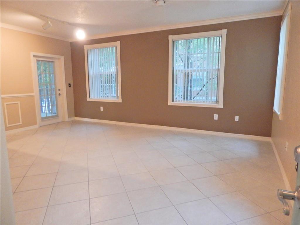 6670 West Sample Road, Unit 6670 Coral Springs, FL 33067 - Photo 5 of 16 an empty room with windows and closet