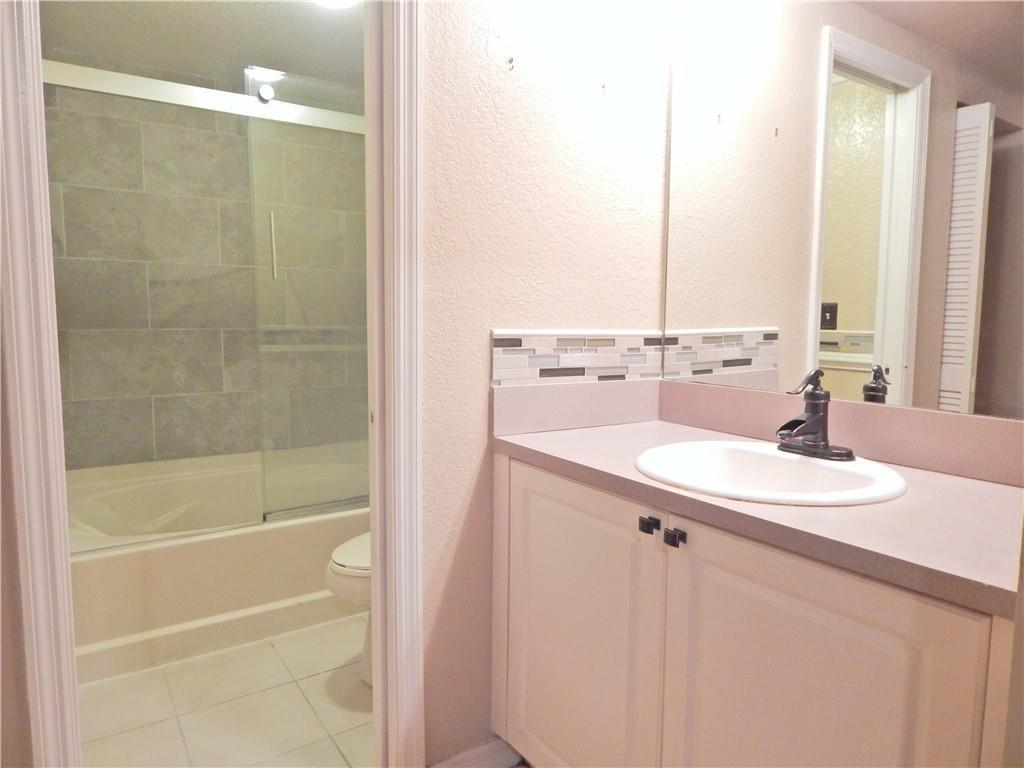 6670 West Sample Road, Unit 6670 Coral Springs, FL 33067 - Photo 10 of 16 a bathroom with a sink double vanity and a mirror