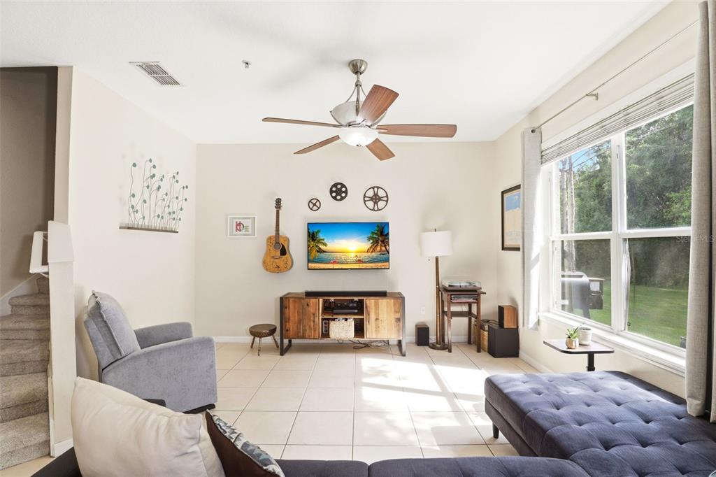 6458 South Goldenrod Road, Unit 29B Orlando, FL 32822 - Photo 7 of 40 a living room with furniture a flat screen tv and a large window