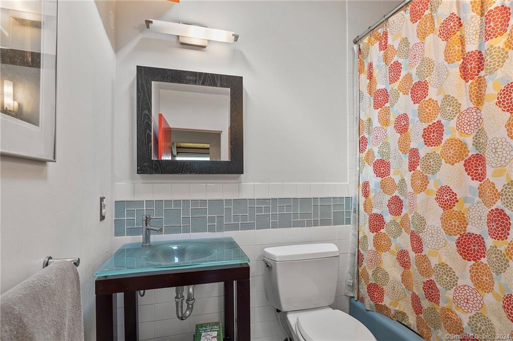 47 Florida Hill Road Ridgefield, CT 06877 - Photo 12 of 29 a bathroom with a toilet sink and mirror