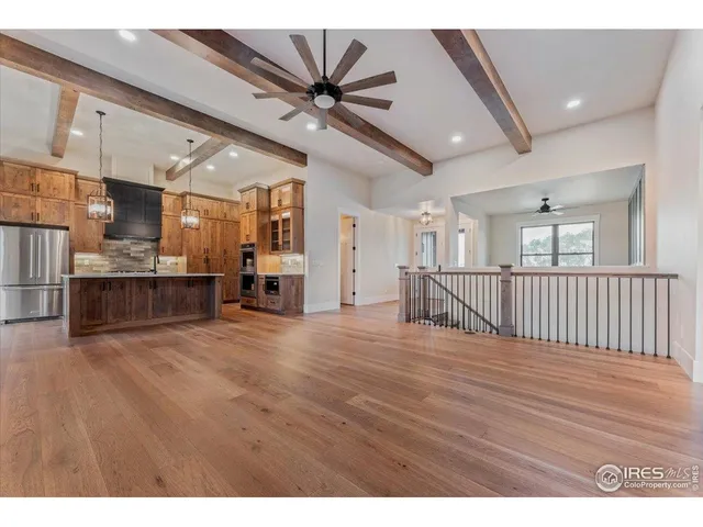 a kitchen with kitchen island a sink appliances and a counter top space