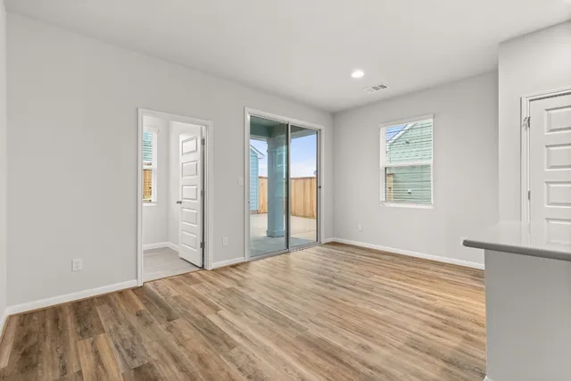 a view of a room with wooden floor and window