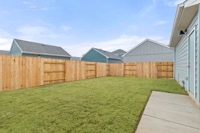 a view of a house with a yard and garage