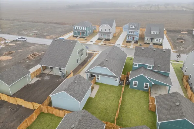 an aerial view of a house with a ocean view