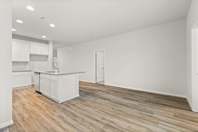 a kitchen with granite countertop white cabinets and white appliances
